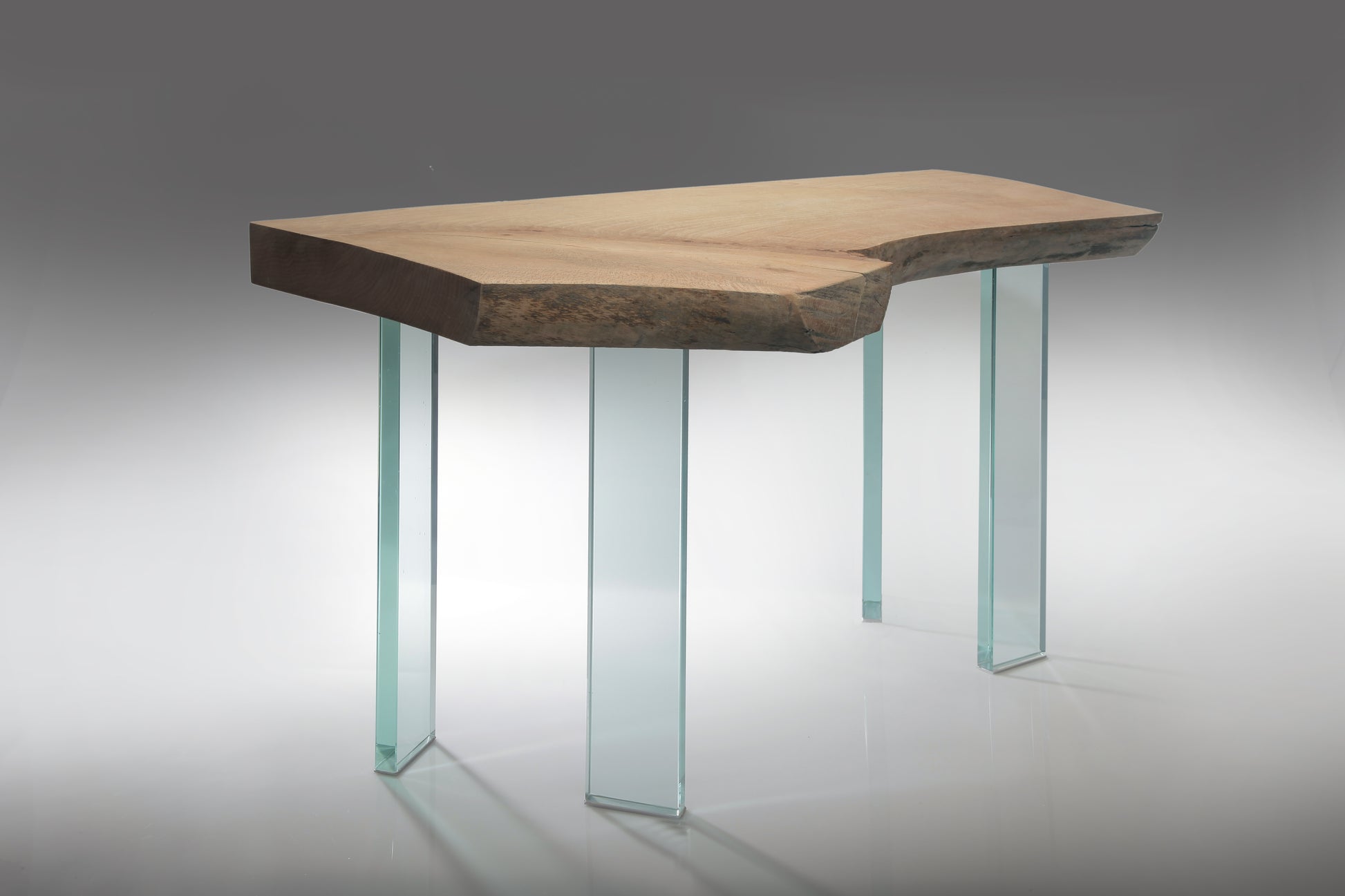 Wooden table with glass legs on a gradient background